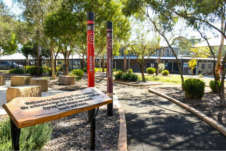 A landscape image of Bonnyrigg Public School with the yarning circle and Welcome to Country in the foreground.